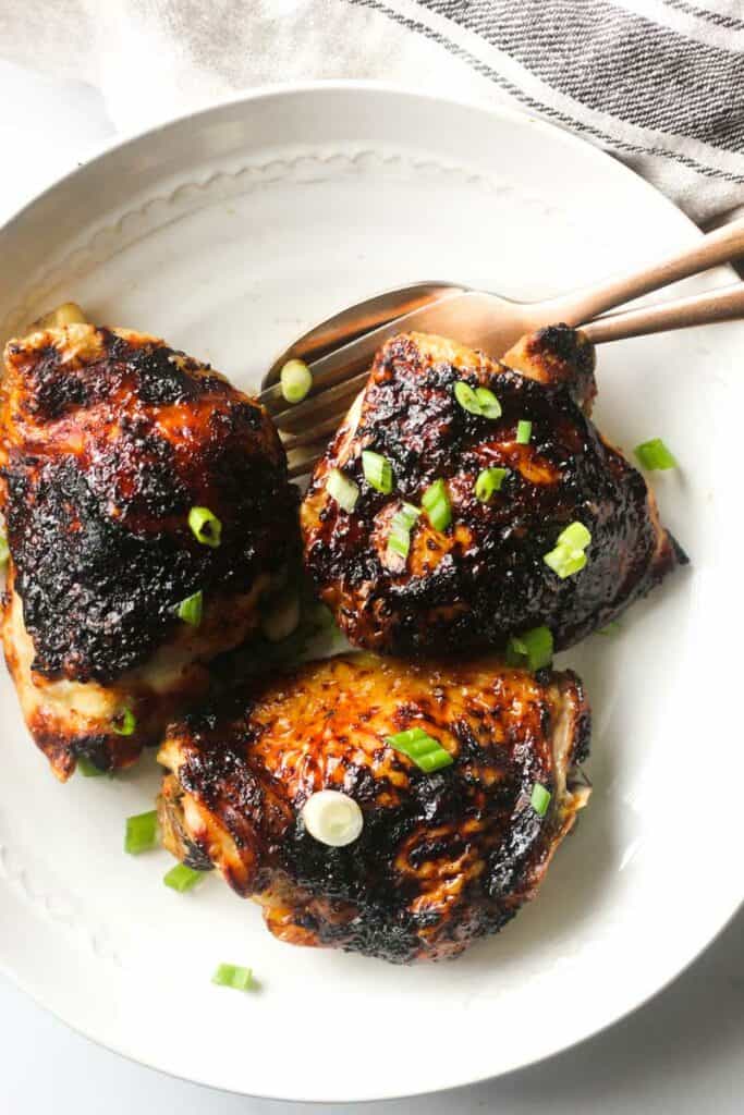 air fryer bbq chicken thighs with chopped green onions on top