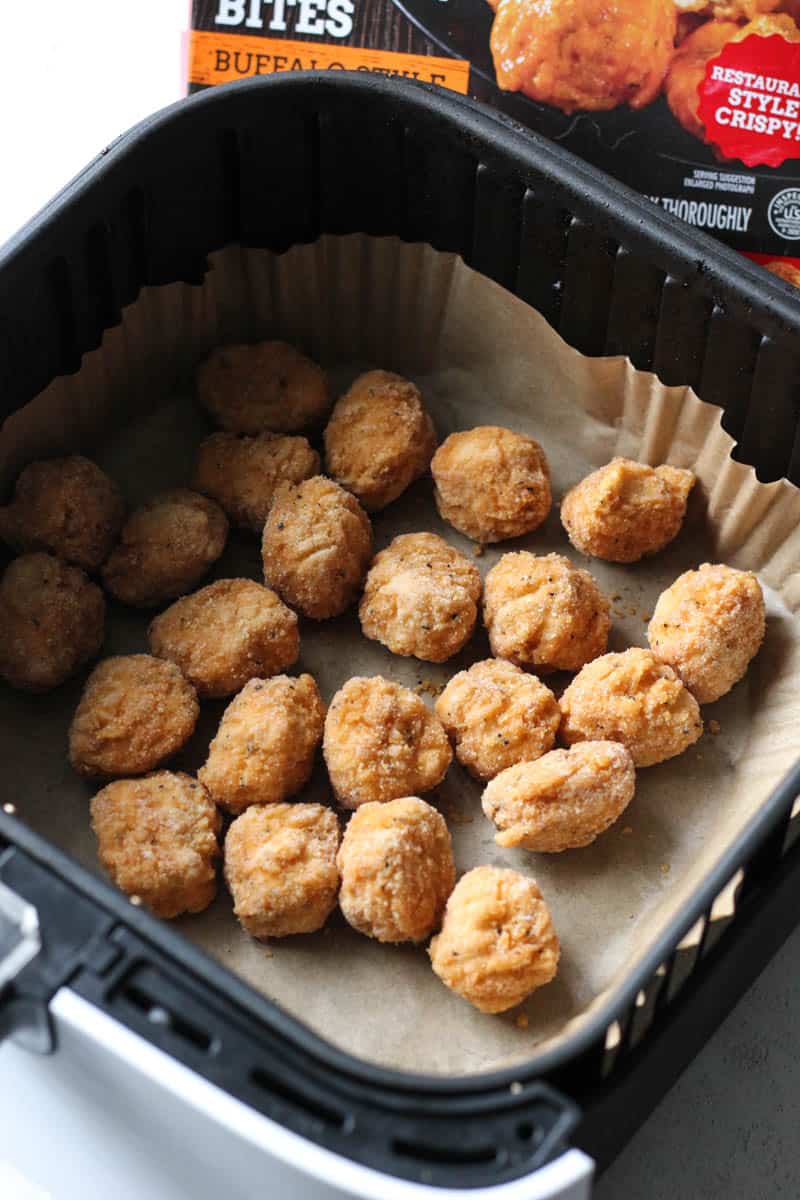 frozen uncooked breaded chicken bites in the air fryer basket
