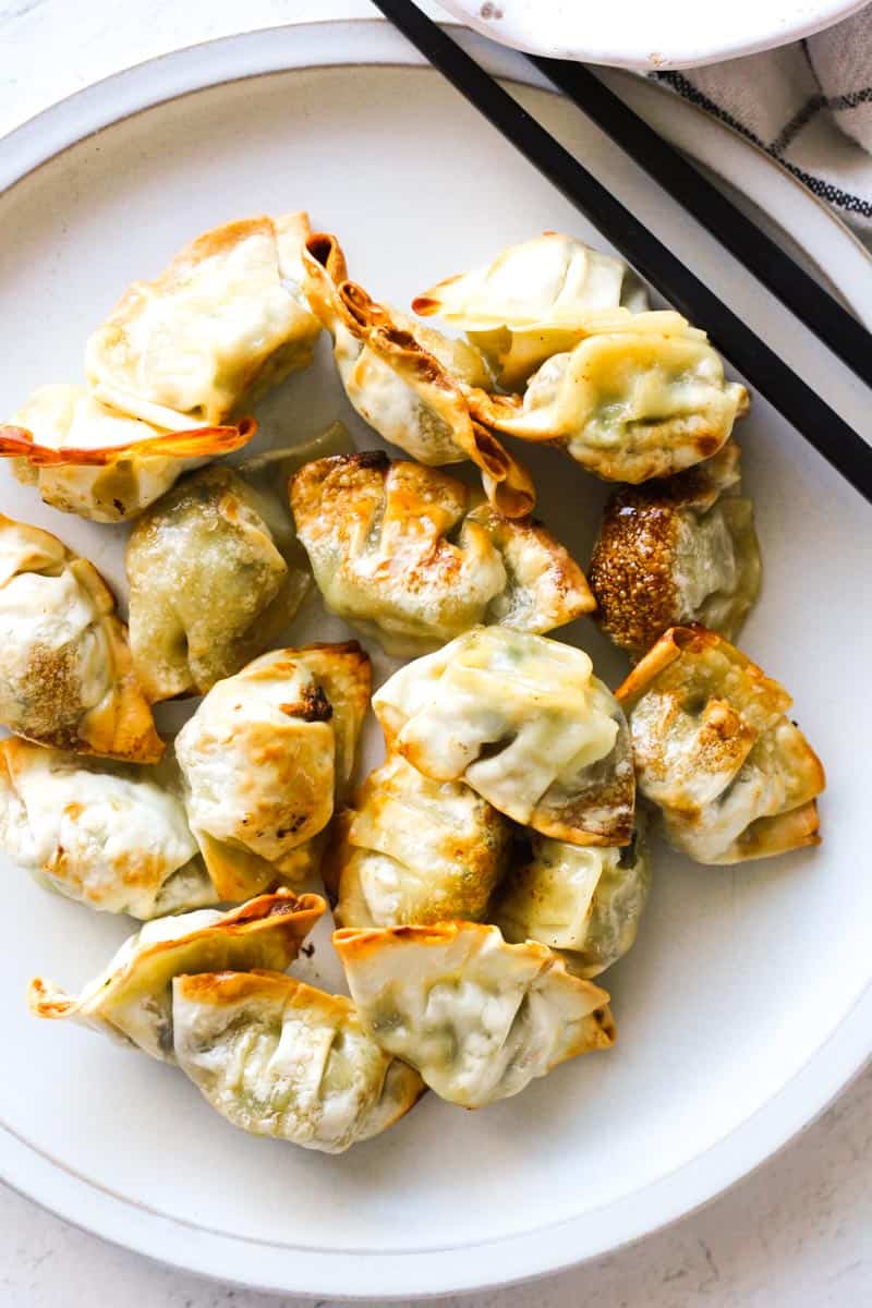 air fryer bibigo mini dumplings on the white plate