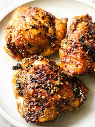 air fryer jerk chicken thighs cooked in air fryer on the white plate