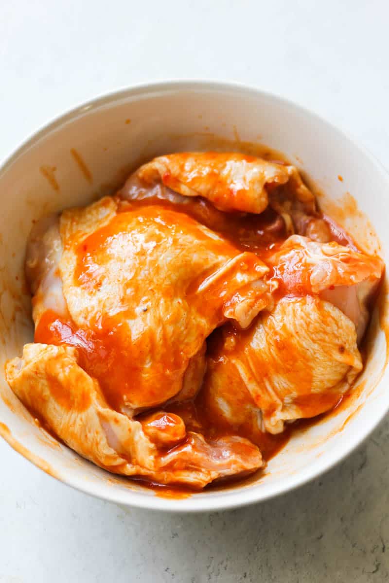 chicken thighs covered in red orange sauce