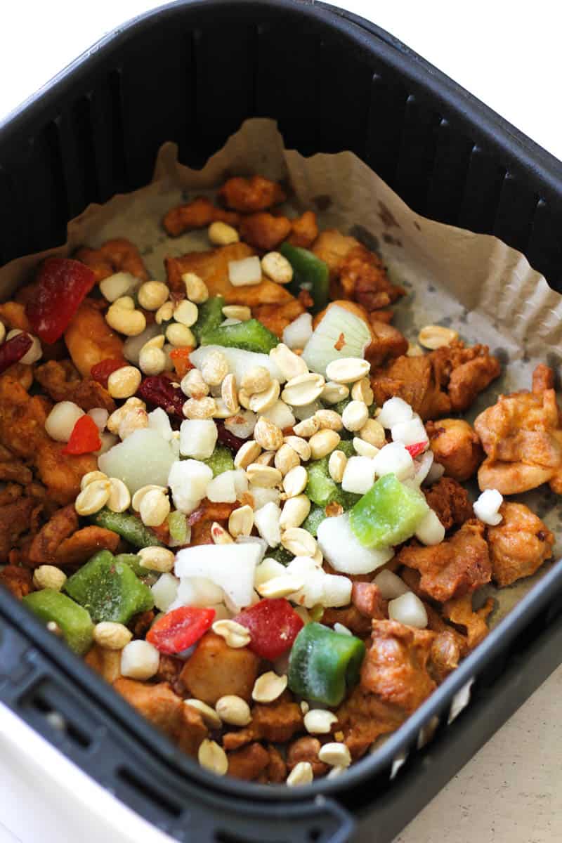 vegetables and peanuts on the chicken in the air fryer