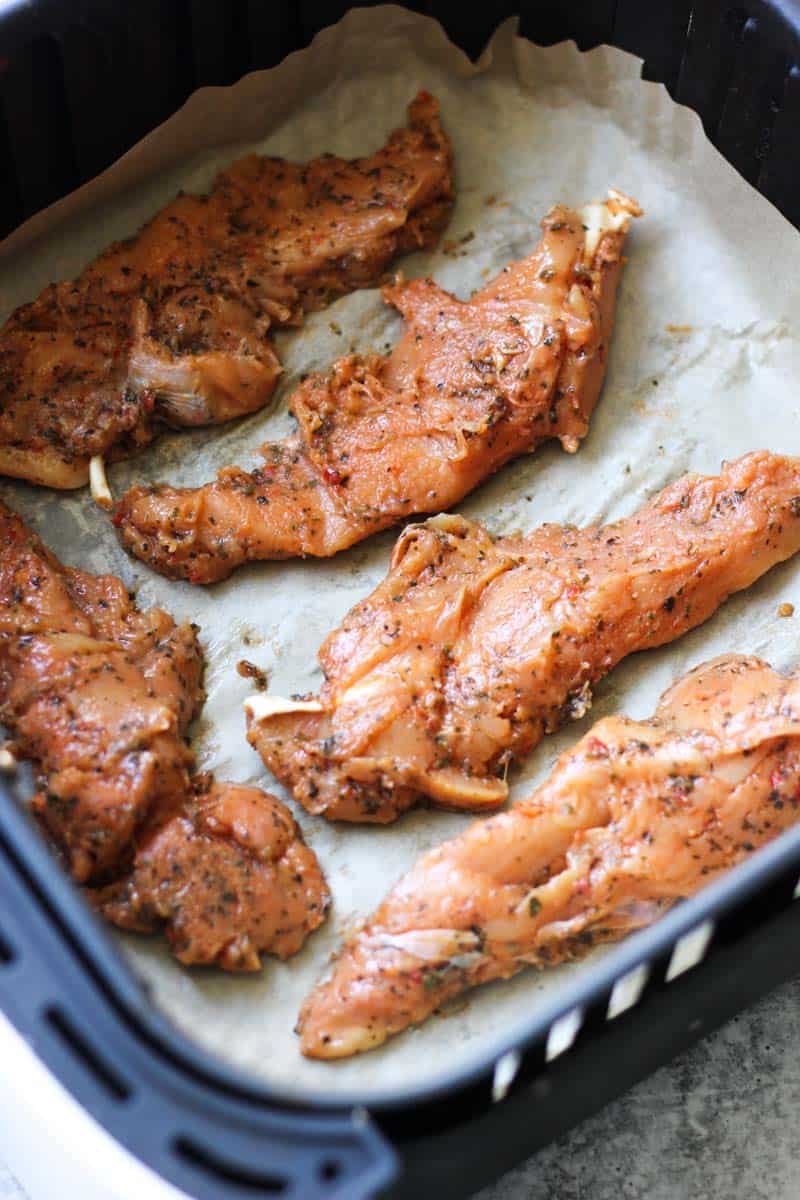 raw chicken tenders in air fryer before cooking