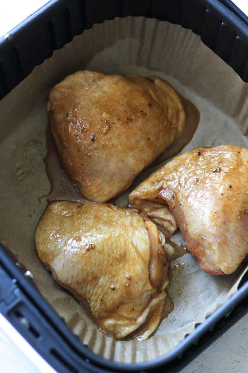 seasoned marinated chicken thighs with skin on in the air fryer before cooking