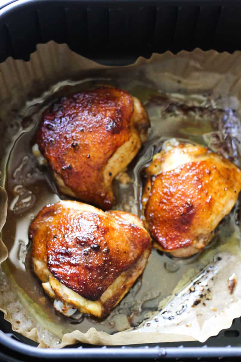 chicken thighs in the air fryer with maple crispy skin top view