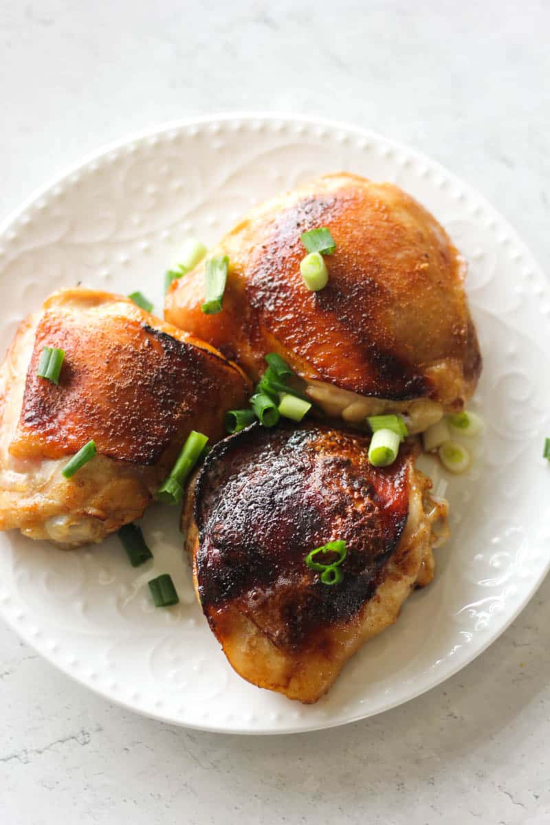 soy sauce chicken thighs on the the white plate