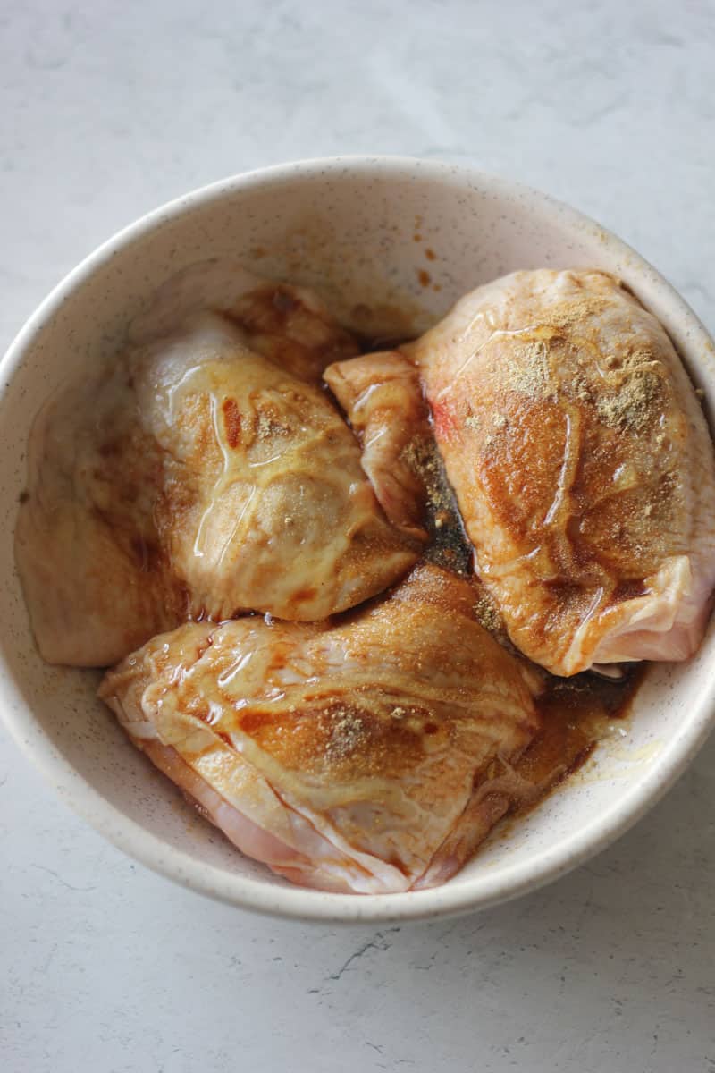 seasoned chicken thighs in the bowl